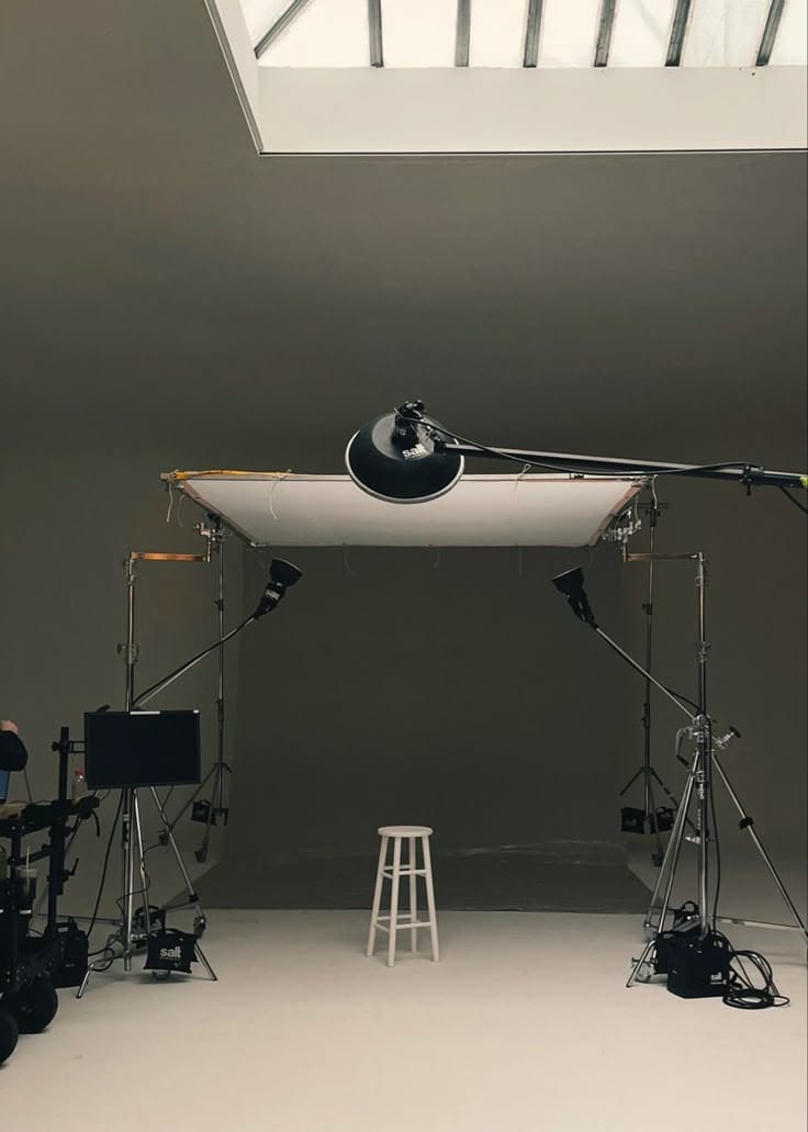 a photo studio with a white table and a stool burlington nc